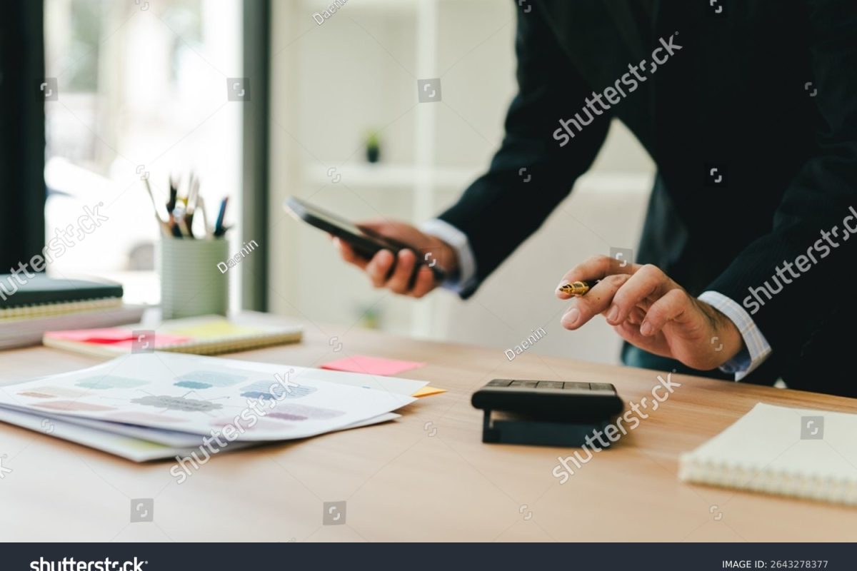 stock-photo-portrait-working-on-smartphone-and-calculating-tax-in-modern-office-preparing-accounting-analysis-2643278377